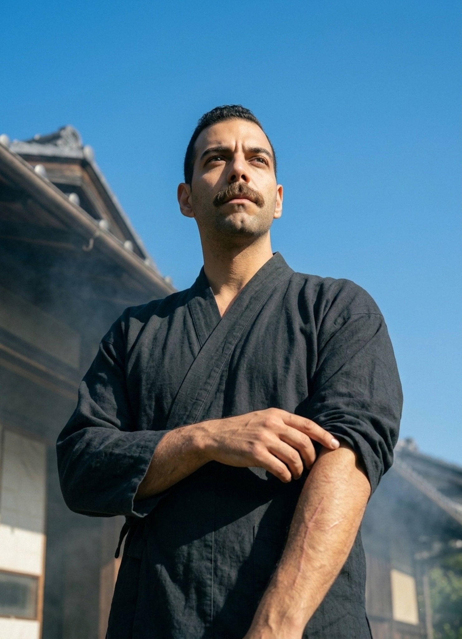 Person looking up at clear blue sky touching arm scars with purposeful expression